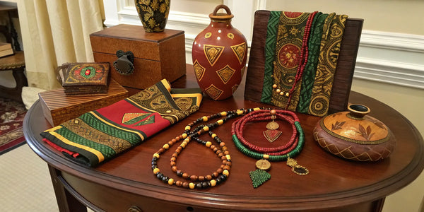 A collection of Afrocentric gift sets featuring jewelry, patterned fabrics, and decorative boxes.