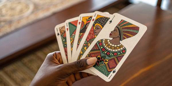 A hand holding Black art playing cards with designs celebrating Black culture.