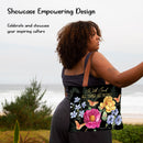 Woman holding a tote bag with floral design and text by the beach