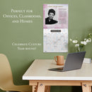 Calendar on a wall above a desk with a laptop and mug, with text about its use in offices, classrooms, and homes.