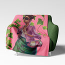 Green and Pink Blanket draped over a chair displaying its soft texture and illustrated design