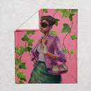 Folded Green and Pink Blanket showing partial design of the stylish woman with green leaves on a pink background