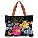 Tote bag with floral design and 'With God All Things Are Possible' text on a black background