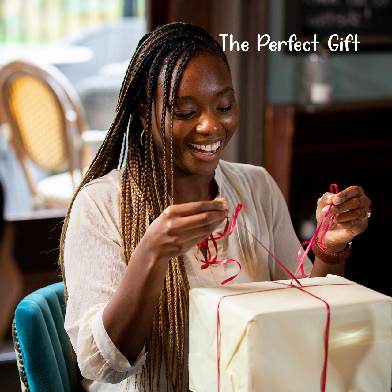 Woman happily opening a package containing the Woman with God Canvas Bag presented as the perfect gift