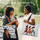 Two women standing and showcasing different designs of the Woman with God Canvas Bag